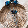 Three metal roses bundled together, welded steel bouquet