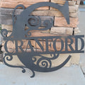 Custom metal monogram sign mounted on wall