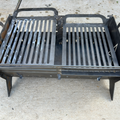 Collapsible fire pit assembled and lit outdoors